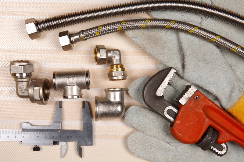 Plumber working on pipes in a Abbots Langley home